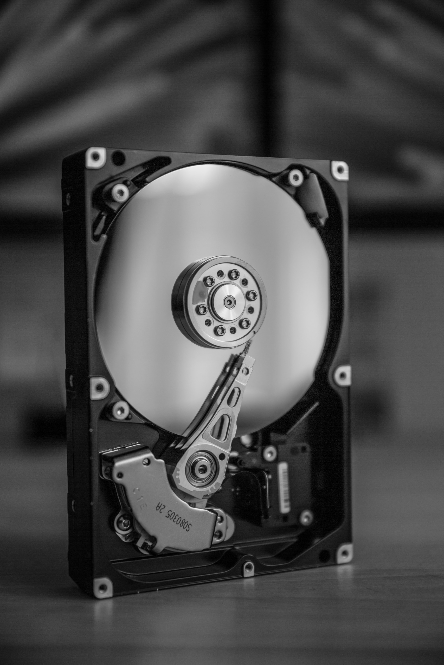 A black and white photograph displaying a hard drive, an integral part for repairing your DVD player at One Hour Device Repair.