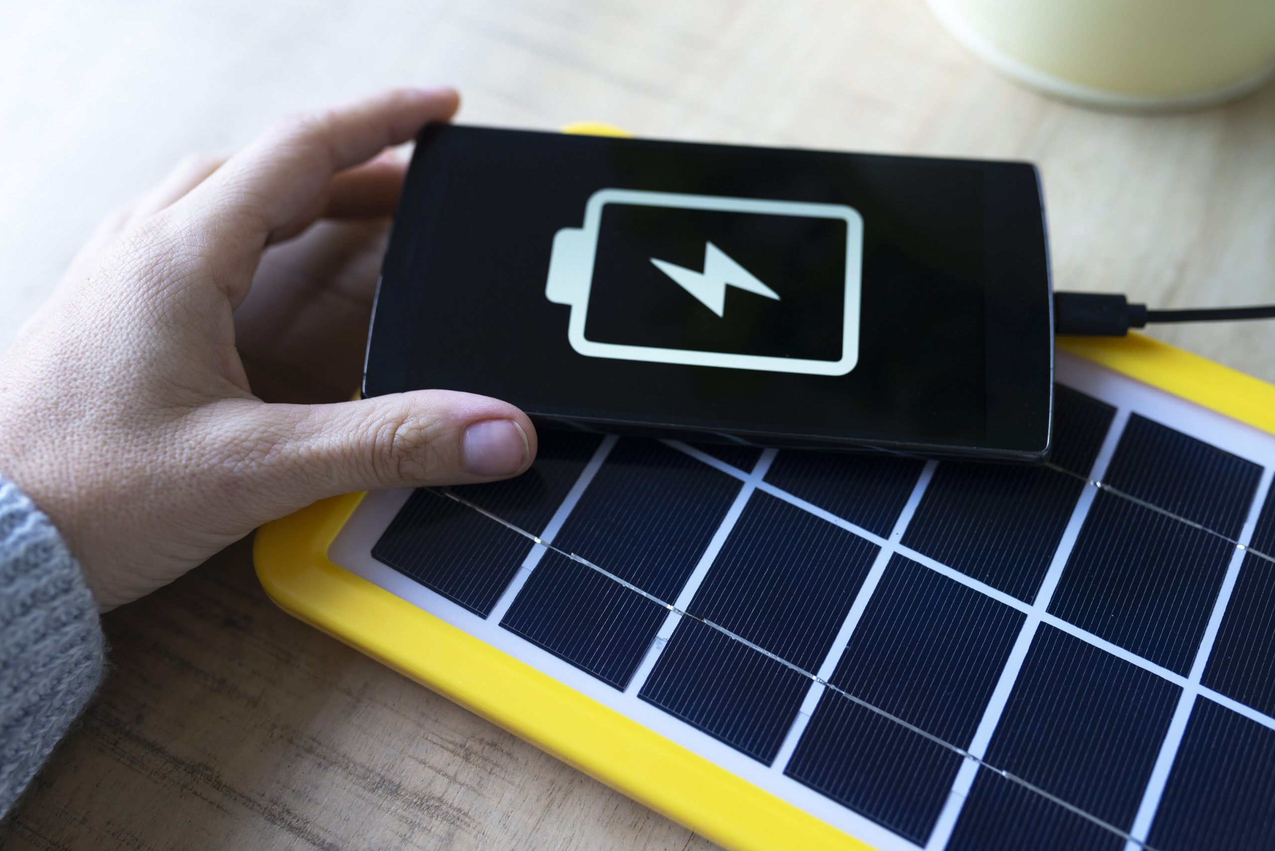 Renewable energy technology, solar panel charging a mobile phone battery