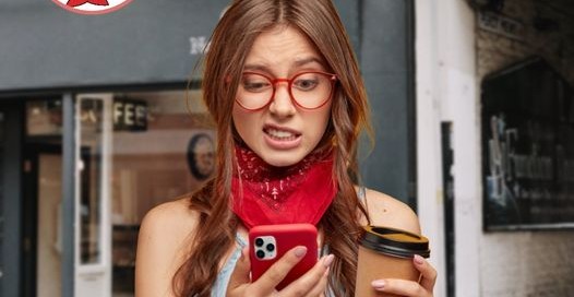 A woman wearing glasses sips coffee and holds a cell phone, promoting One Hour Device Repair services.